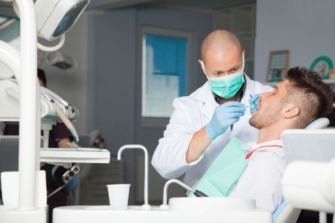 Doctor Fixing Man's Teeth
